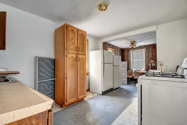 a kitchen with stainless steel appliances granite countertop a refrigerator and a stove