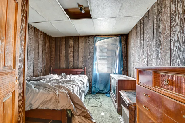 a bed sitting in a bedroom next to a window