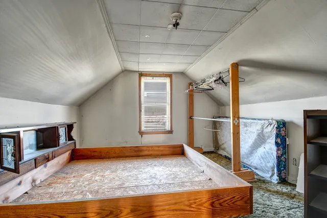 a view of a livingroom with wooden floor and a ceiling fan