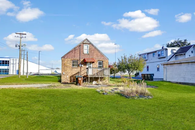 a view of a house with a big yard and a fountain