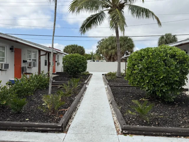 a front view of a house with parking area