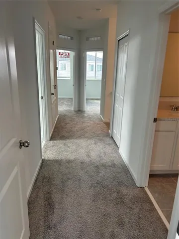 a view of a hallway with wooden shelves