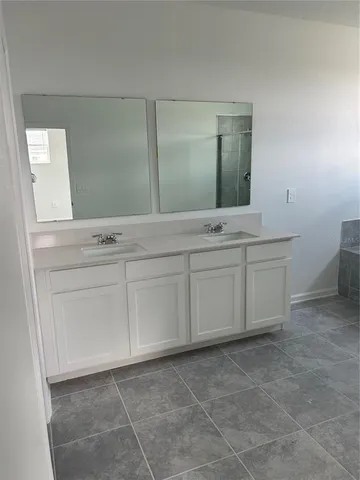 a bathroom with a sink vanity and mirror