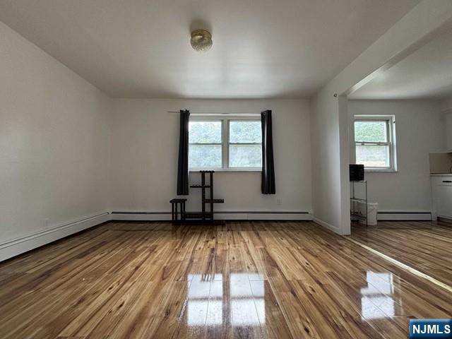 2004 Hoefleys Lane Fort Lee, NJ 07024 - Photo 5 of 9 an empty room with wooden floor and windows