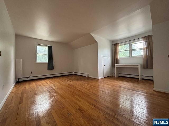 2004 Hoefleys Lane Fort Lee, NJ 07024 - Photo 7 of 9 an empty room with wooden floor and windows