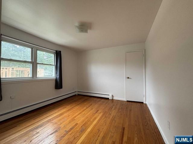 2004 Hoefleys Lane Fort Lee, NJ 07024 - Photo 8 of 9 an empty room with wooden floor and windows