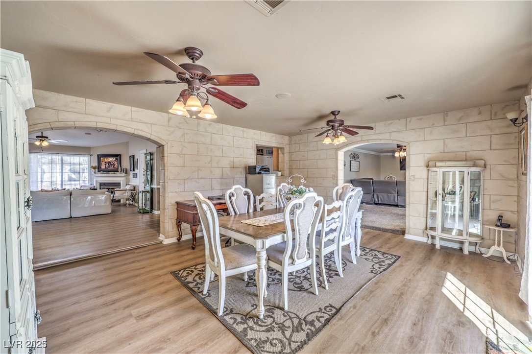 3192 North Taylor Street Logandale, NV 89021 - Photo 16 of 36 Dining space with light wood-type flooring, ceiling fan, and tile walls