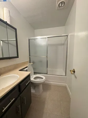 a bathroom with a toilet a sink and shower