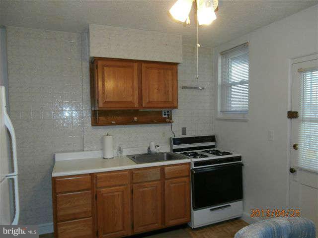 1639 Yakona Road Baltimore, MD 21286 - Photo 8 of 16 a kitchen with stainless steel appliances a cabinets and a stove top oven