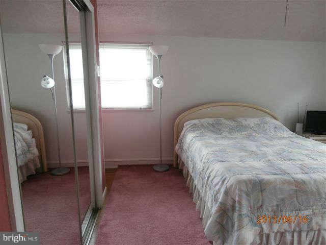1639 Yakona Road Baltimore, MD 21286 - Photo 9 of 16 a bed sitting in a room next to a window