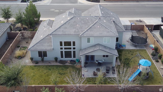 429 East Treasure Road Washington, UT 84780 - Photo 36 of 36 Rear view of house featuring stucco siding, a fenced backyard, a patio area, and a tiled roof