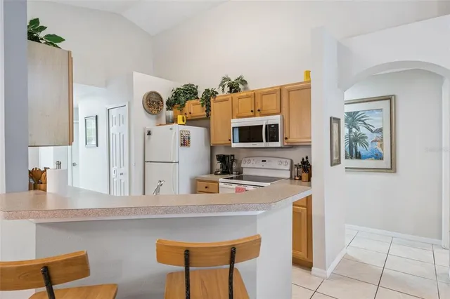 a kitchen with stainless steel appliances granite countertop a sink and a refrigerator