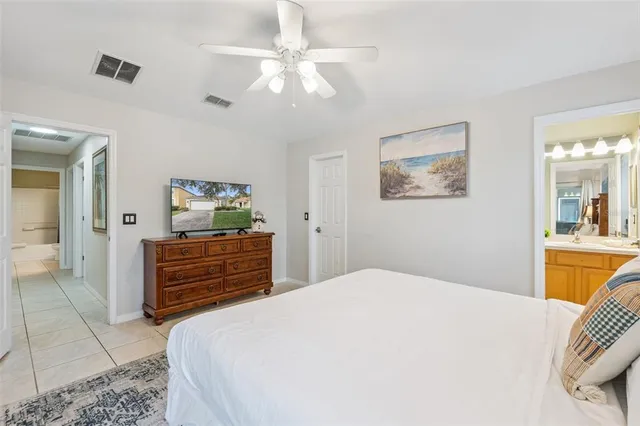 a bedroom with a bed and a flat tv screen next to a window