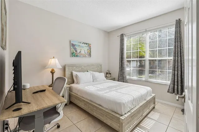 a bedroom with a bed a rug and a window