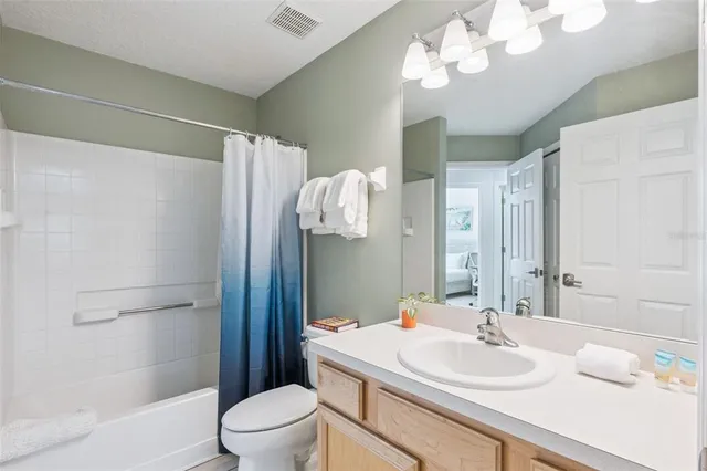 a view of a dining room with furniture and a chandelier