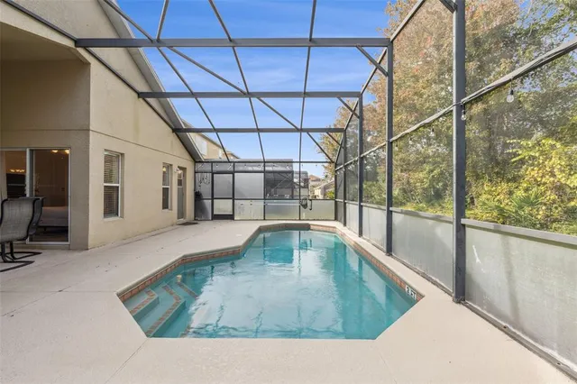 an aerial view of residential houses with outdoor space and swimming pool