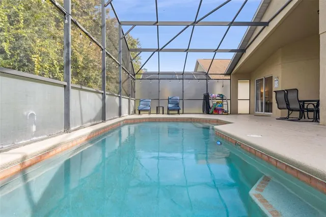 an aerial view of residential houses with outdoor space and lake view