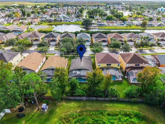 an aerial view of a house with a swimming pool yard and outdoor seating