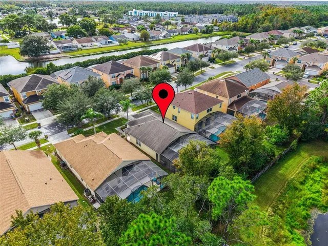 an aerial view of a house with a yard and garden