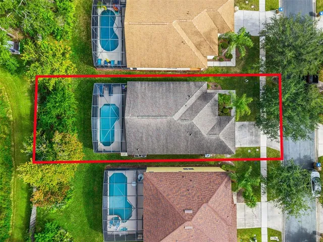 an aerial view of a city with lots of residential buildings ocean and mountain view in back