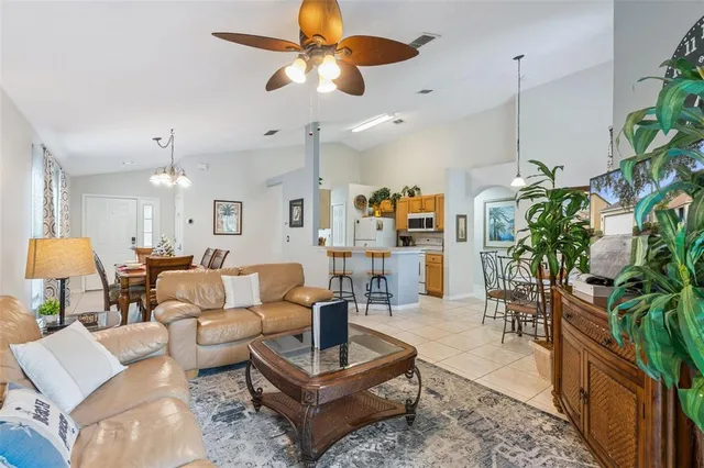 a living room with patio furniture and a potted plant