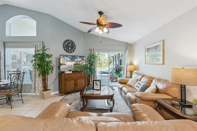 a living room with furniture a chandelier and a window