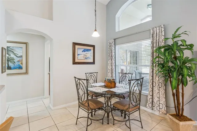 a view of a dining room with furniture and a potted plant