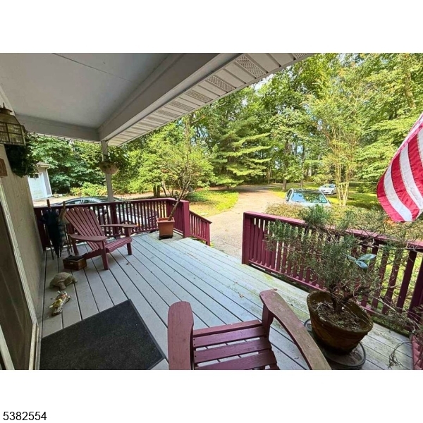 1036 Potts Mill Road Bordentown, NJ 08505 - Photo 41 of 48 a balcony with wooden floor outdoor seating and yard in the back