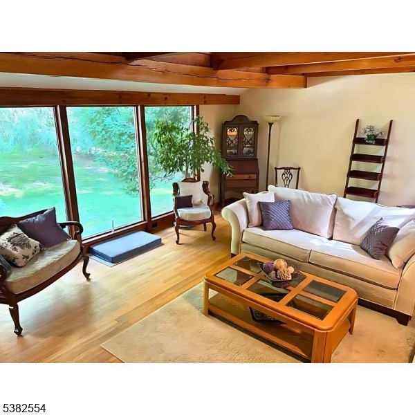 1036 Potts Mill Road Bordentown, NJ 08505 - Photo 5 of 48 a living room with furniture a rug and a floor to ceiling window
