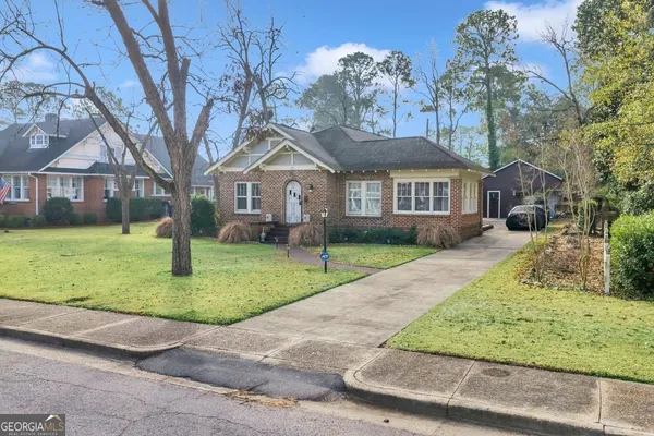 an aerial view of a house with a yard