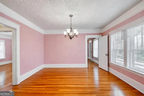 a living room with furniture a rug and a large window