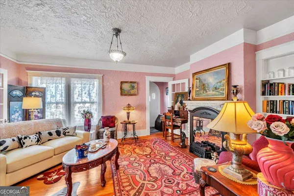 a living room with furniture a fireplace and a flat screen tv