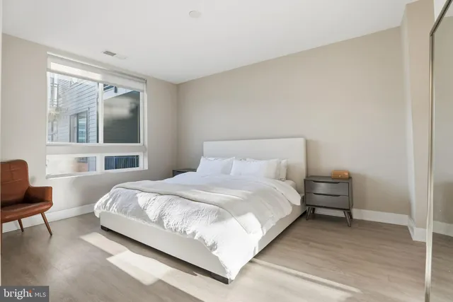 a bedroom with a bed and a chair