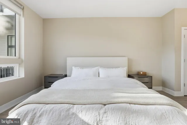 a bedroom with a bed and a night stand