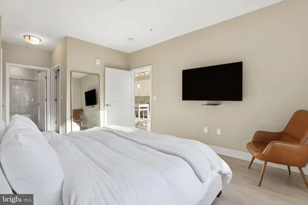 a bedroom with a bed and a flat screen tv