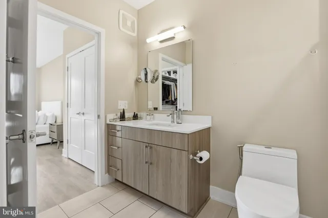 a bathroom with a toilet sink and mirror