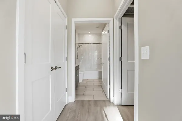 a view of a hallway with wooden floor