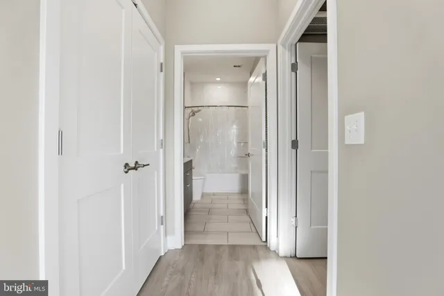 a view of a hallway with wooden floor