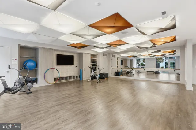 a room with lots of wooden furniture and a chandelier