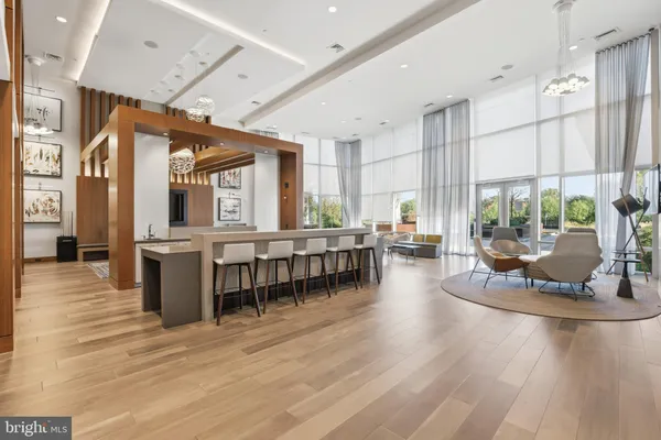 a dining hall with stainless steel appliances granite countertop a stove and chairs