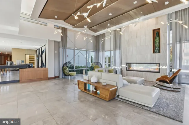 a living room with furniture and large windows