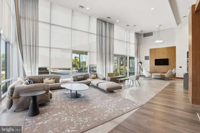 a living room with furniture large window and flat screen tv