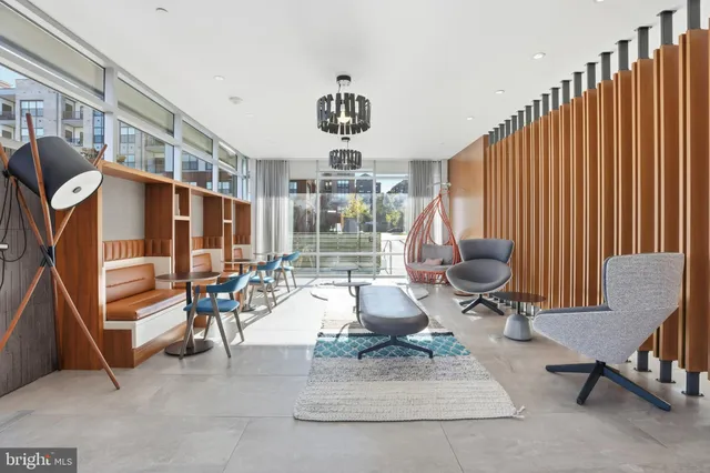 a living room with furniture a rug and white walls