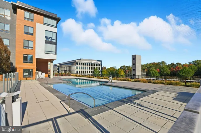 a view of swimming pool with outdoor seating and city view