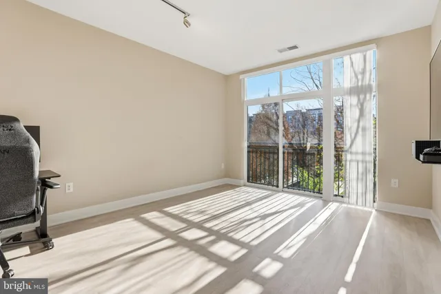 a bedroom with a bed and a large window