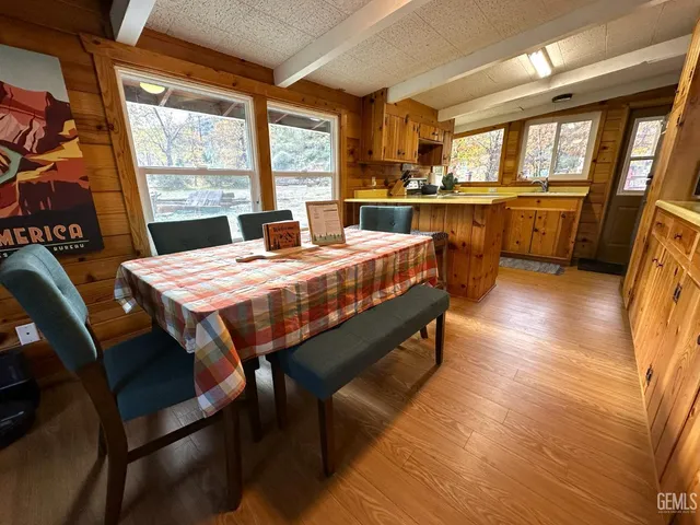 a large kitchen with a table chairs and wooden floor