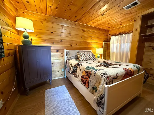 a bed sitting in a bedroom next to a window