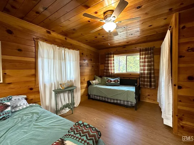 a spacious bedroom with a bed and a chandelier