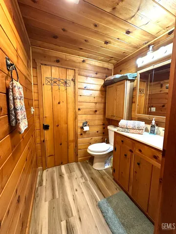 a bathroom with a double vanity sink toilet and shower