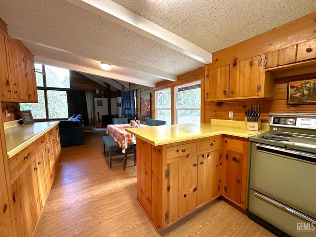 a kitchen with stove a sink and cabinets